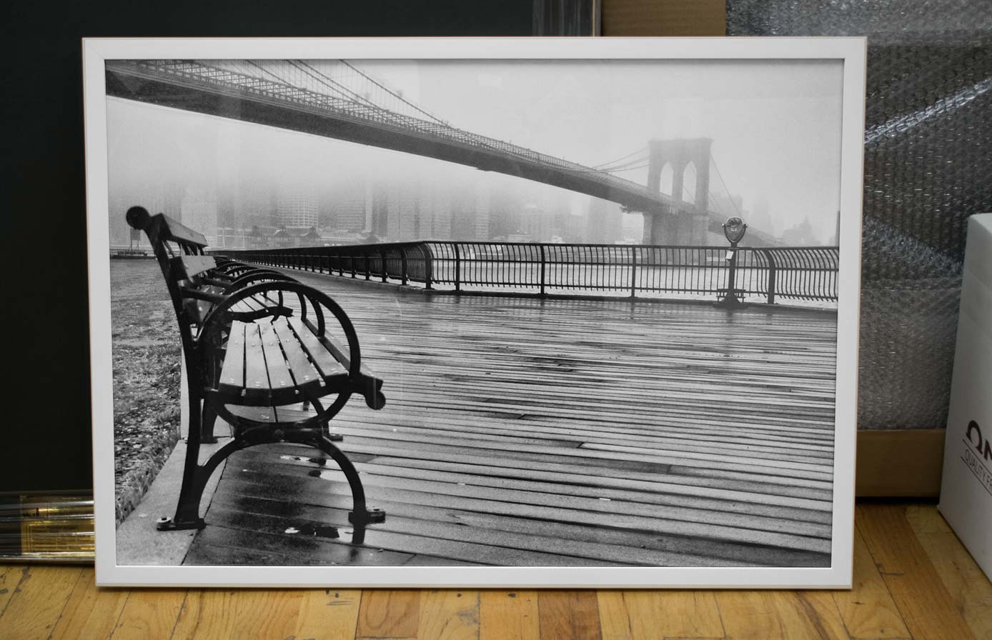 Black-and-white Brooklyn Bridge photograph framed in a clean white frame