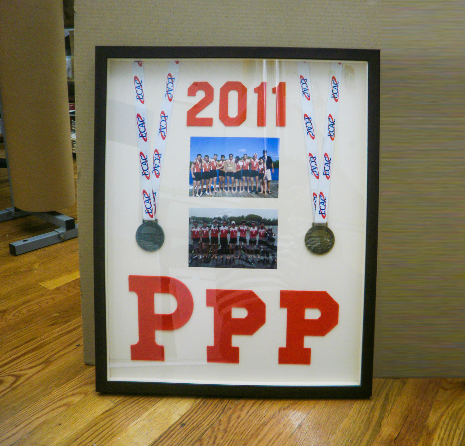 Rowing medals and photos mounted in a shadow box