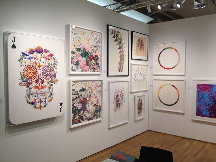 A wall of framed artwork including a decorative skull print