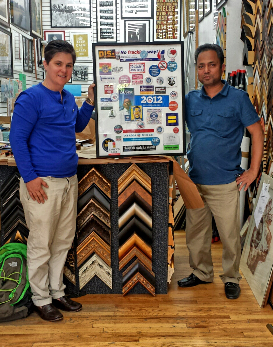 A framed political collage held by the Westside Frame Shop team