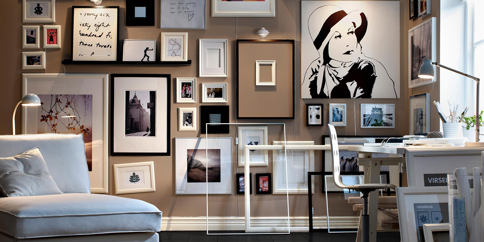 A curated gallery wall of framed black-and-white photography